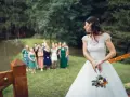 Panna młoda z bukietem ślubnym odwraca się do swoich druhen.